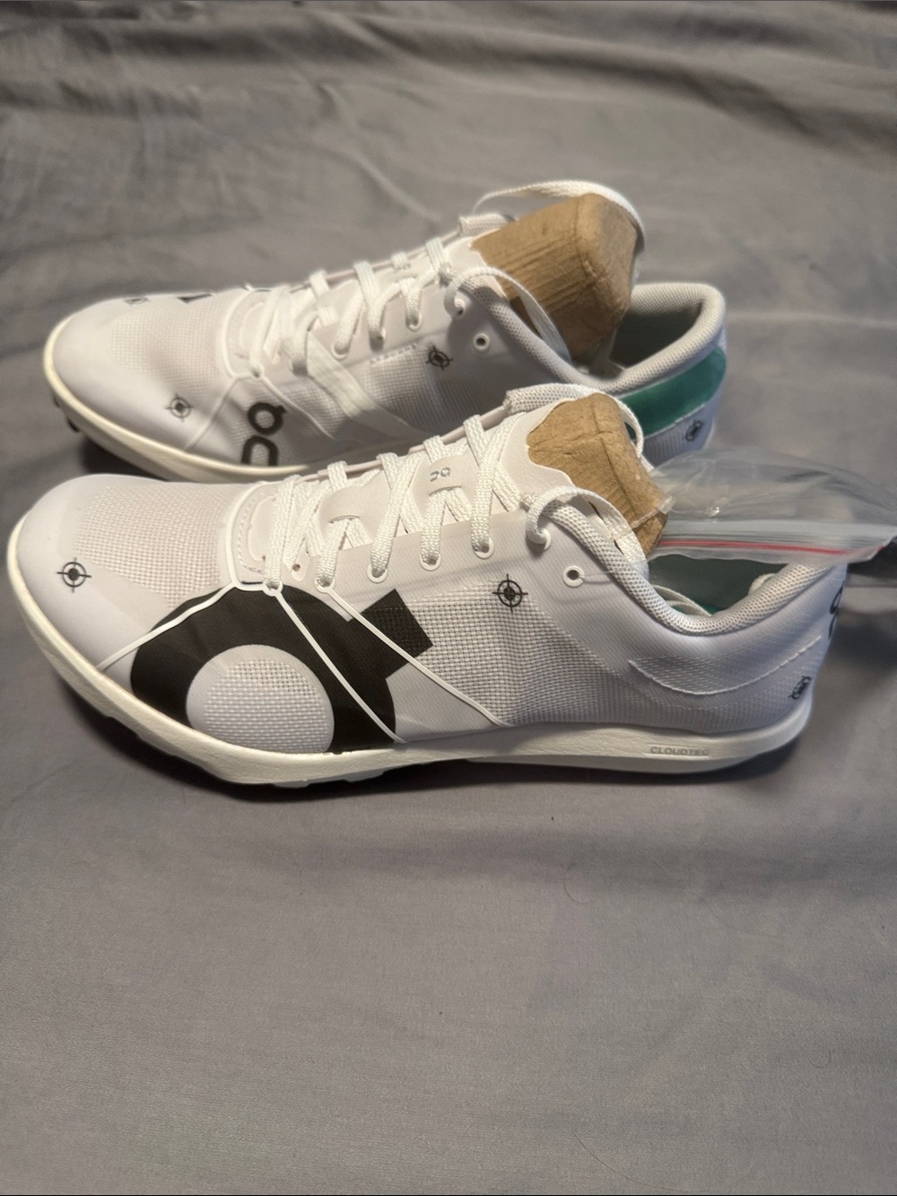 On Running White Cloudspike 10000m. Shoes with Black Logo and Teal Heel Accent